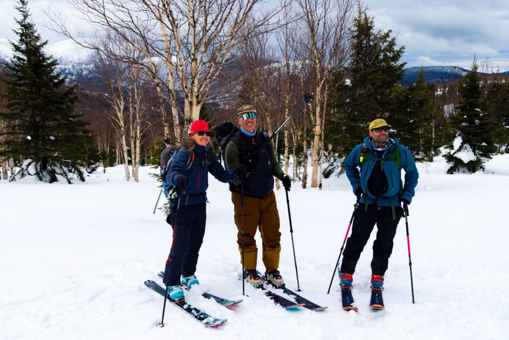 a group of skiers look out at their objective on ernest laforce