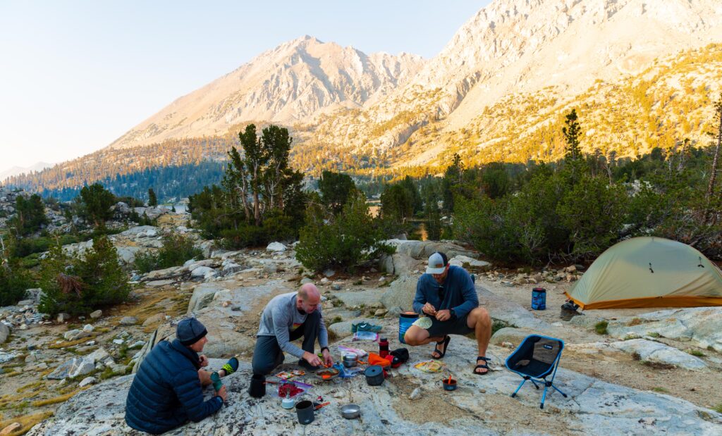 three men use their camping cook ware in the backcountry of kings canyon national park