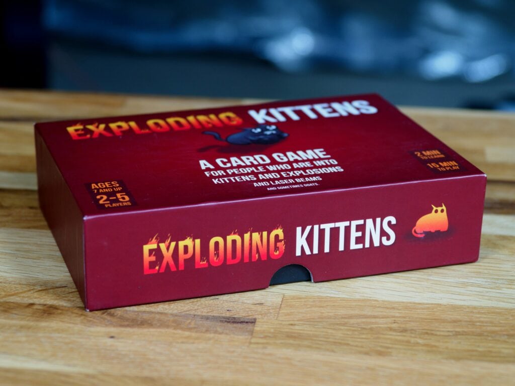the exploding kittens game box on a table