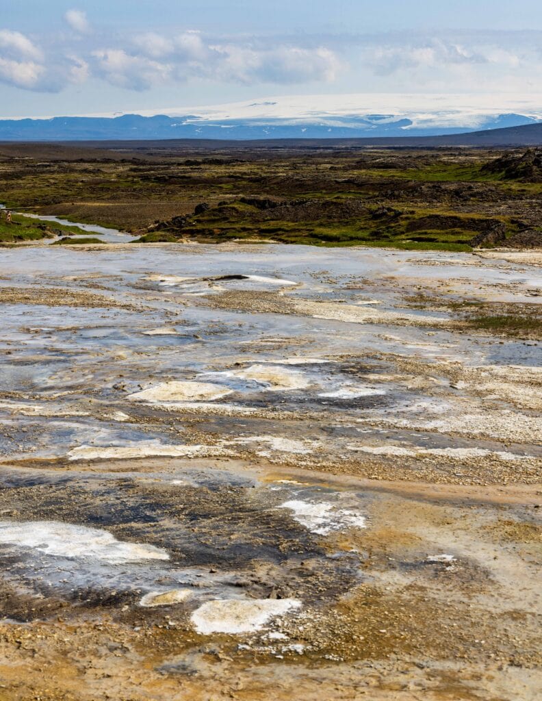 the Hveravellir geothermal area with a large snowcapped mountain in the distance