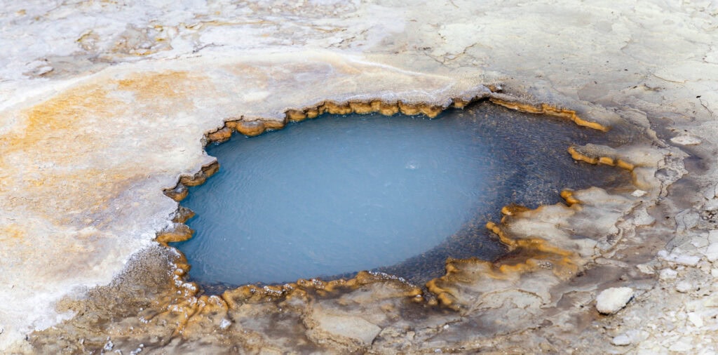 Hveravellir geothermal area in the middle of iceland near the f35 road. here a blue pool sits undisturbed