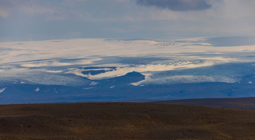 a far off glacier with nothing but dirt for miles and miles