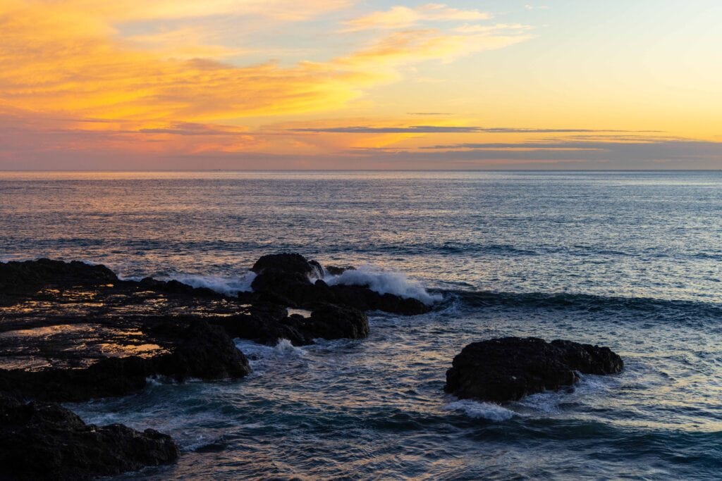 a sunset over the pacific ocean in costa rica