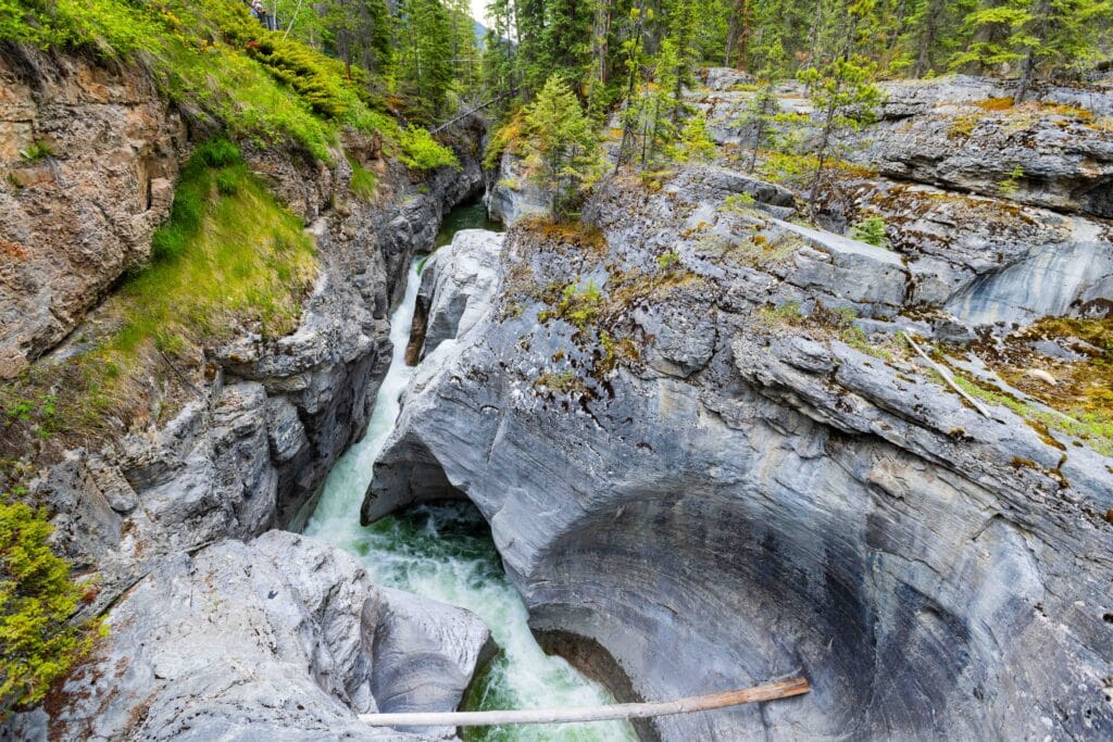 looking down into maligne canyon with waterfalls