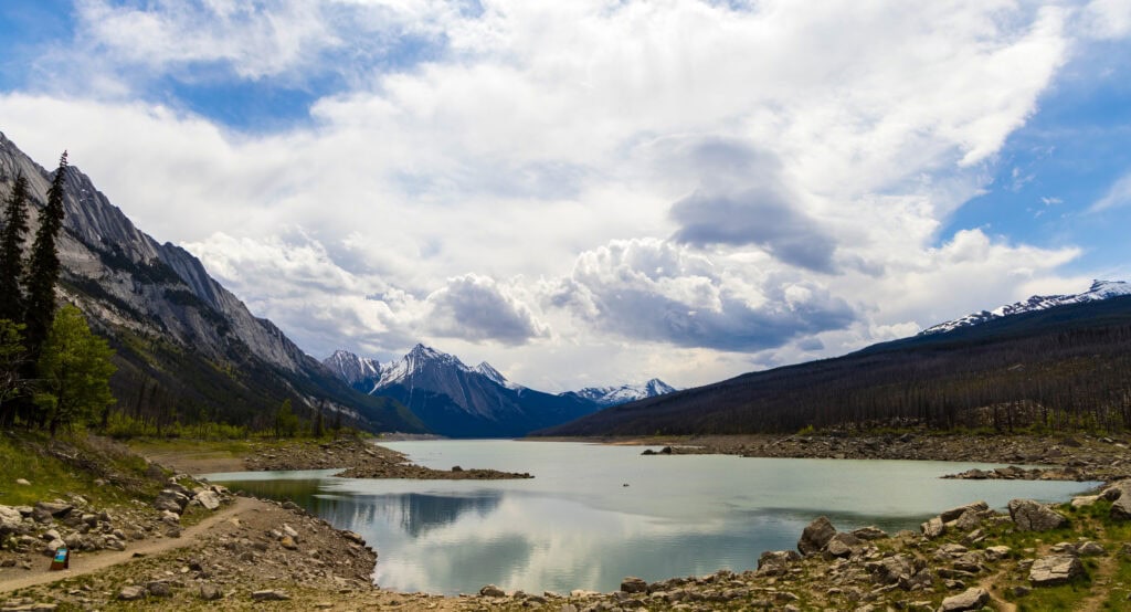 medicine lake in jasper national park with a little reflection of the clouds off its surface