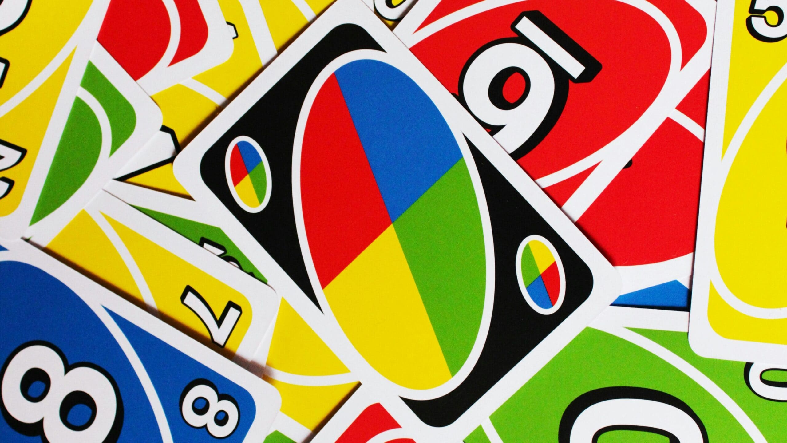 uno cards with a wild card on top