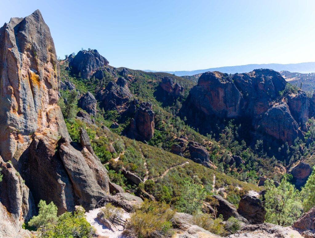 Towering rock spires framed by a narrow canyon opening