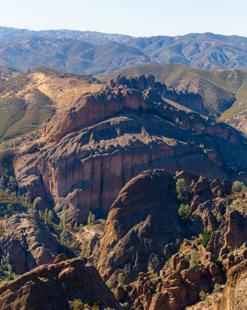 Dramatic canyon walls with warm rust and amber tones under a hazy sky