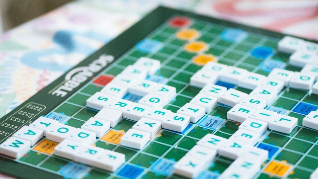 a scrabble board with tile pieces on it