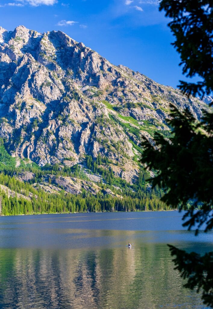 Jagged granite peaks reflected in a calm alpine lake