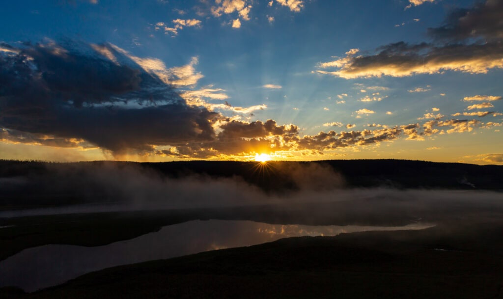 Dramatic cloudscape at dawn over Yellowstone's open landscape