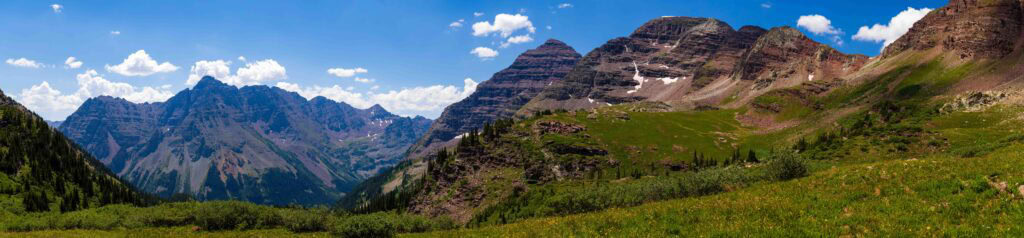 panorama of the maroon bells from a distance valley