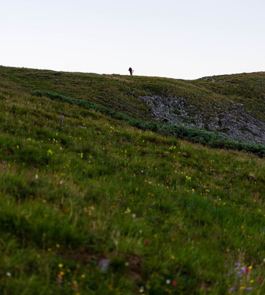a lone hiker high on the ridge in colorado