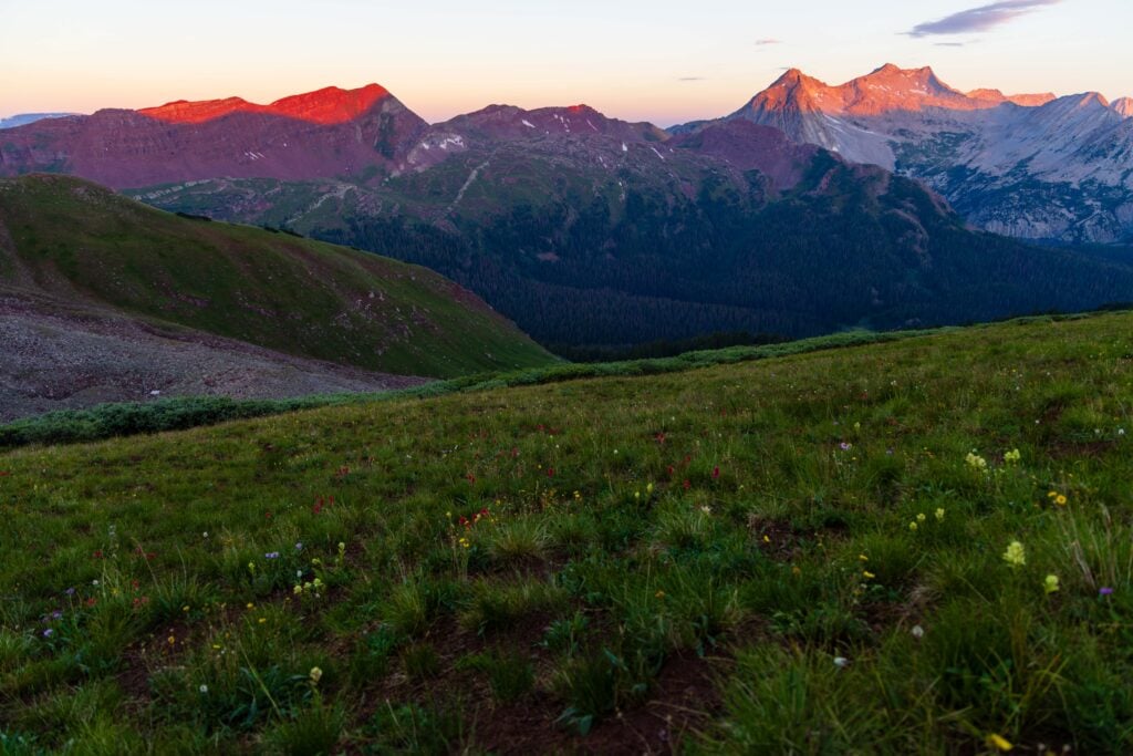 sunrise in colorado illuminating the tops of the mountains