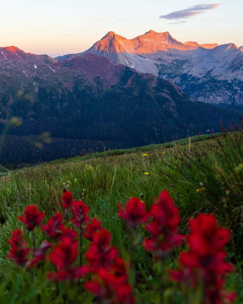 sunrise in colorado illuminating the tops of the mountains