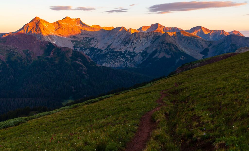 sunrise in colorado illuminating the tops of the mountains