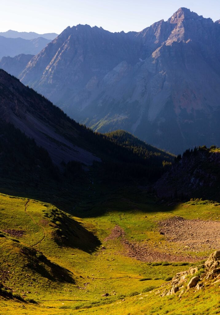 a valley with mountains above in colorado