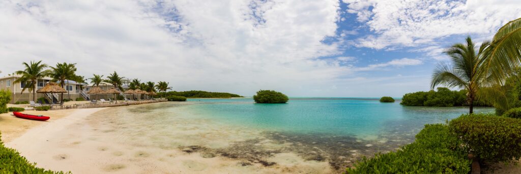a panorama of the beach front at shaka caye resort