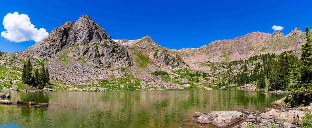 long panorama of gore lake with mountains and trees