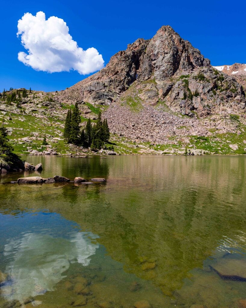 a mountain peak slightly reflecting in gore lake near vail