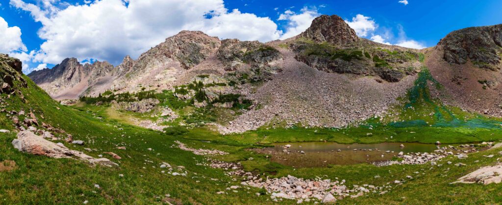 a green and rocky creek basin in colorado