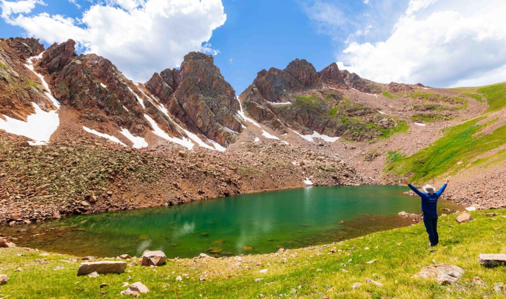 snow lake with towering craggy peaks above