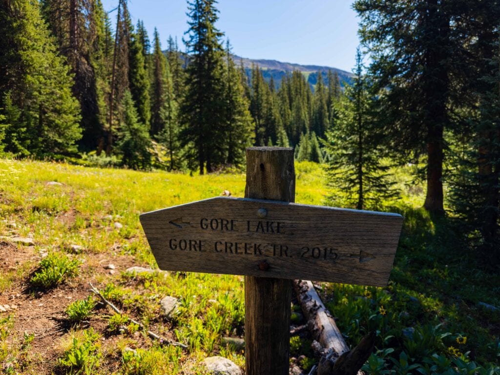 a sign pointing to gore lake or the gore creek trail