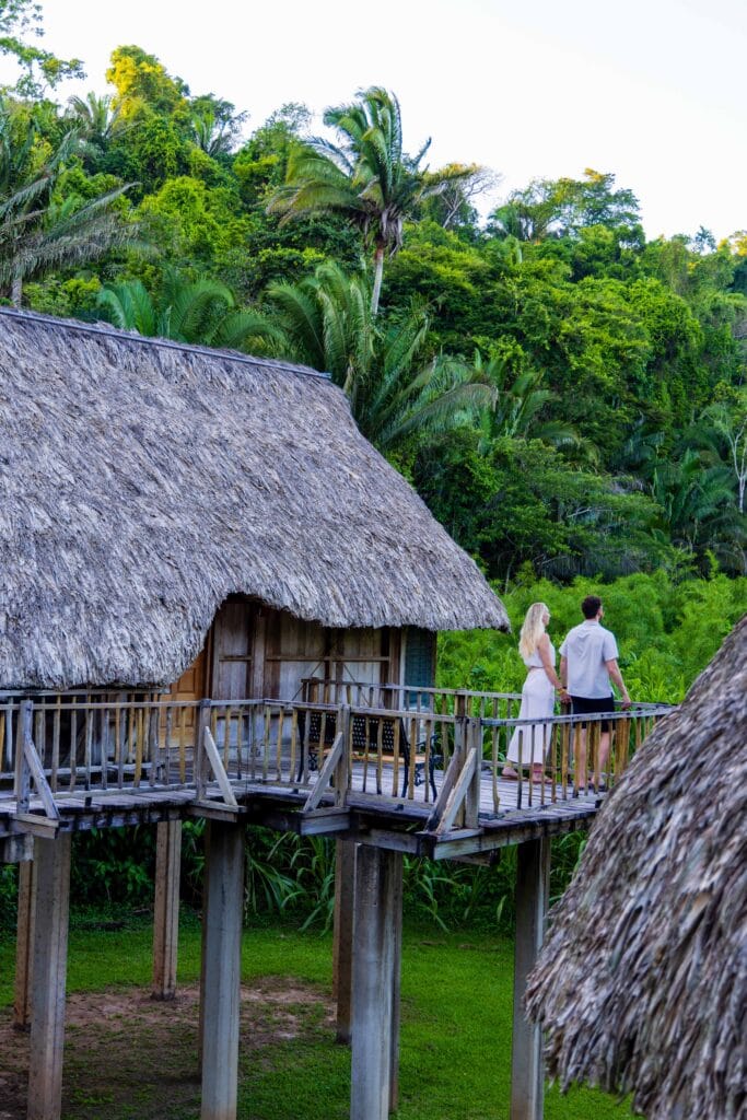 a man and woman stand near their cabana at jade jungle resort