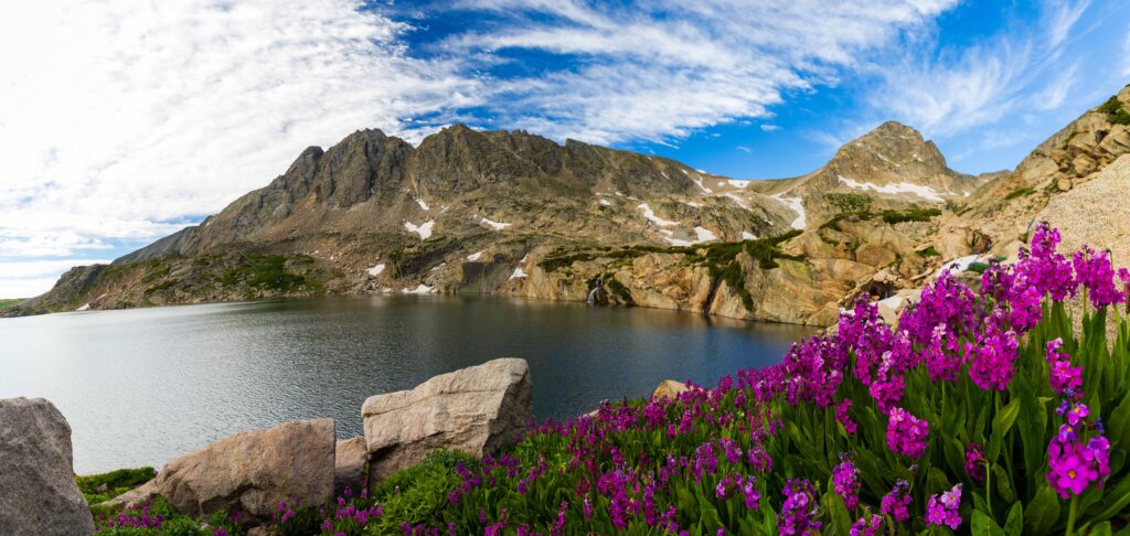 purple mountains with a lake and mountain peaks