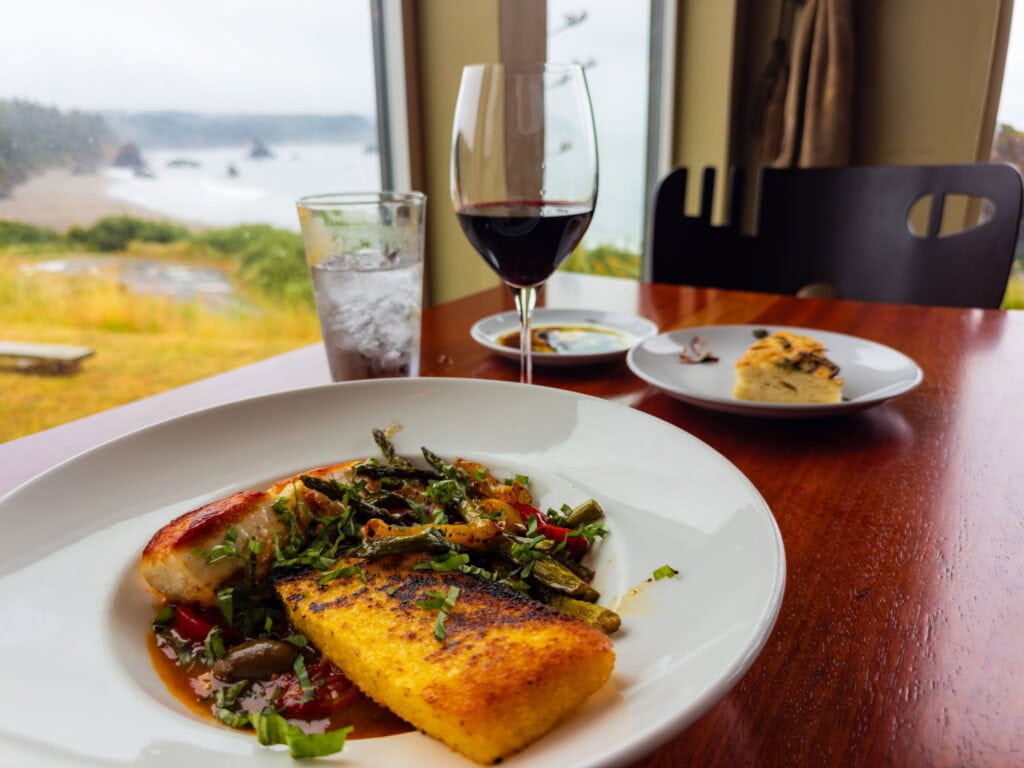 a seafood plate with a glass of wine