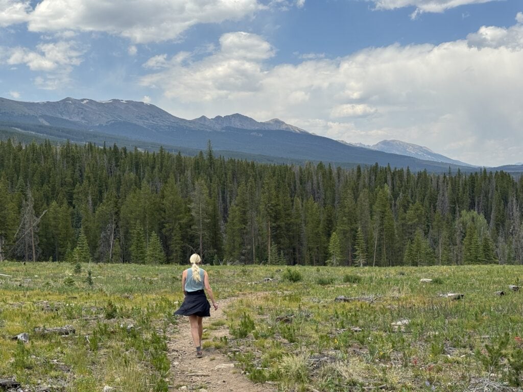 a woman hikes on the burro trail near Breckenridge, CO