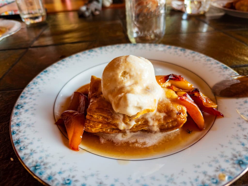dessert with ice cream, apples, and a pastry