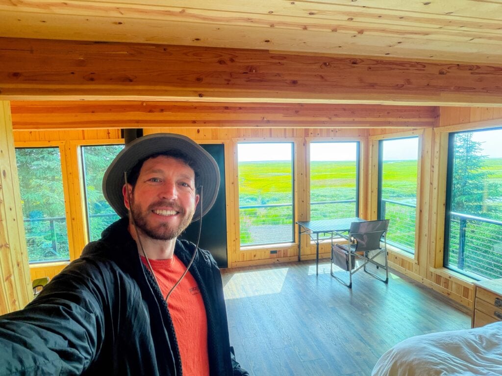 author smiles inside his room at brown bear bay