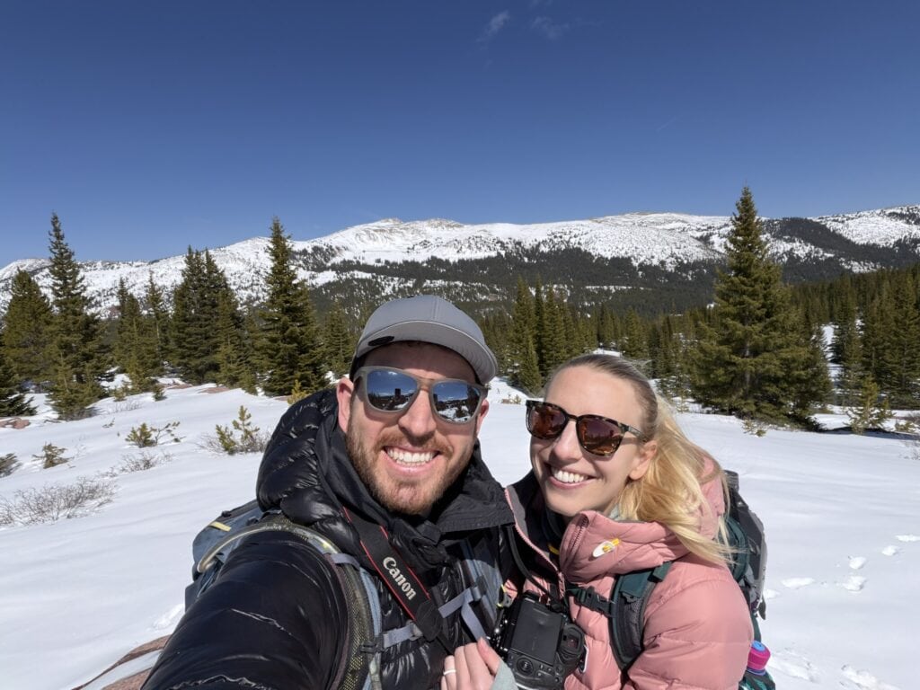 a male and female hiker in the mountains with snow