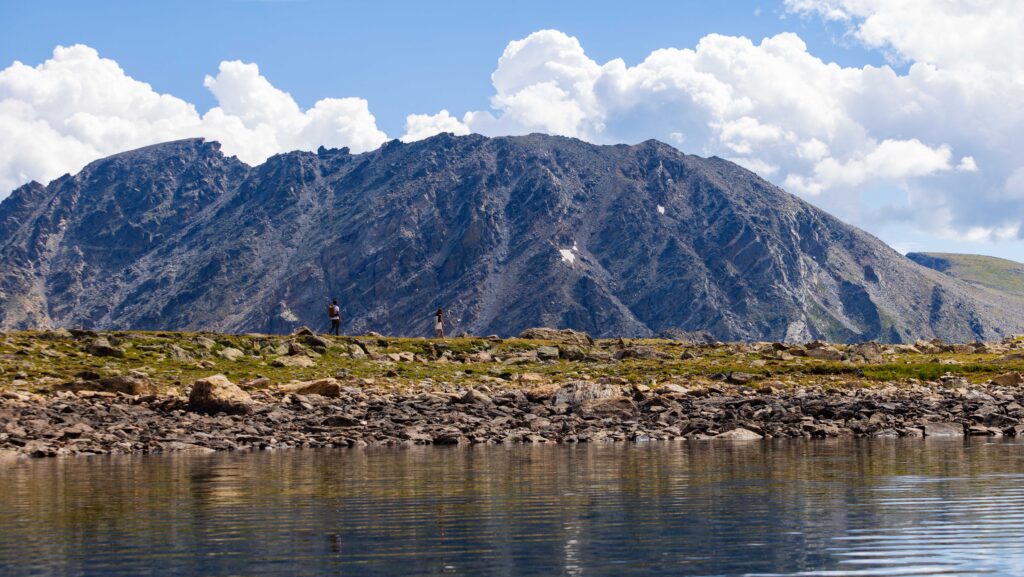 hikers along a small ridge near lake dorothy