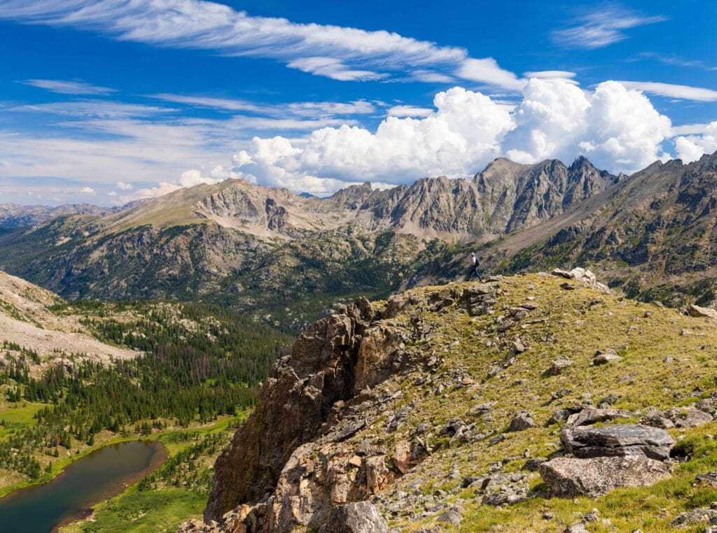 a hiker walking along the ridgeline at arapaho pass in colorado