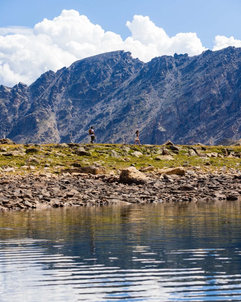 lake dorothy with people on the ridgeline below south arapaho peak