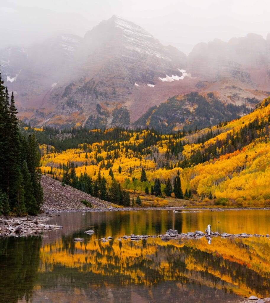 moody maroon bells with fall colors reflecting off the lake