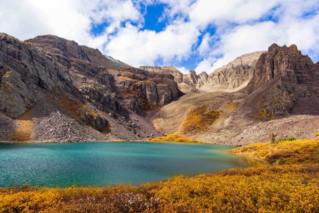 cathedral lake in colorado with tall mountains and fall colors