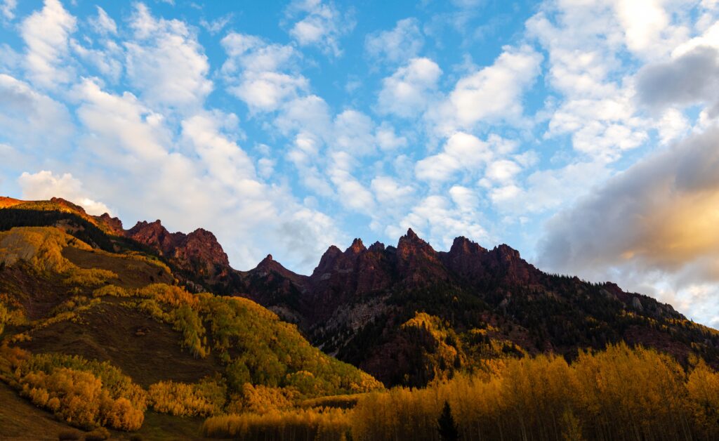 clouds above the jagged peaks near maroon bells