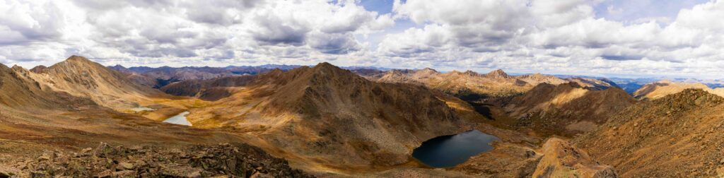 Panoramic view from a summit overlooking an alpine basin with two lakes