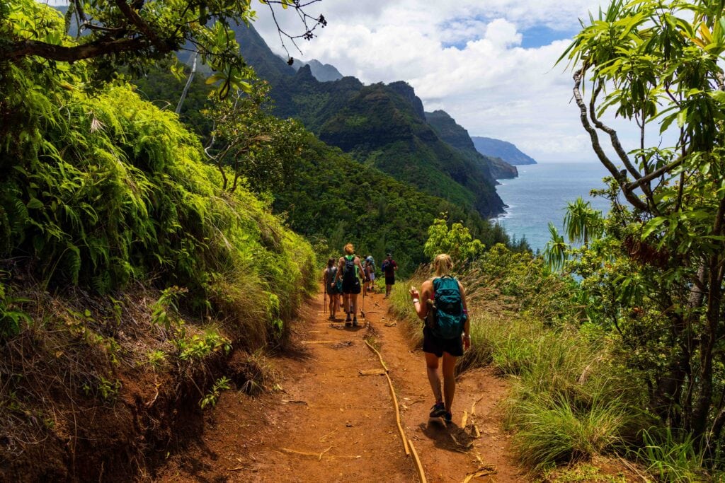 hikers on the hanakapiai beach hike