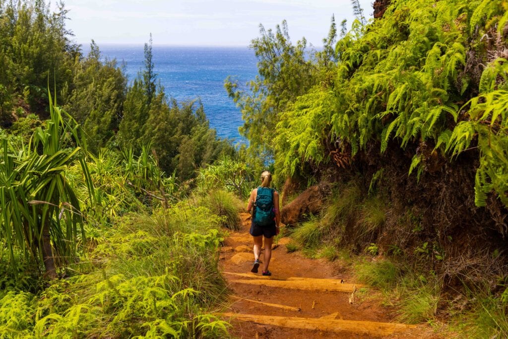 a woman hikes on the Hanakapi'ai beach trail