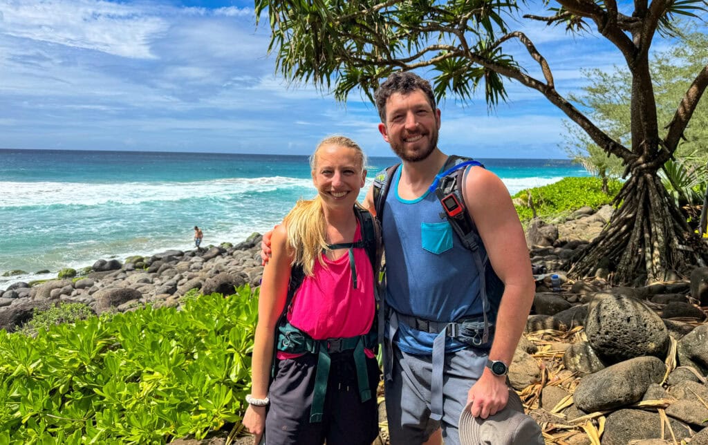 a couple pose for a photo along the Kalalau Trail to Hanakapi'ai Beach