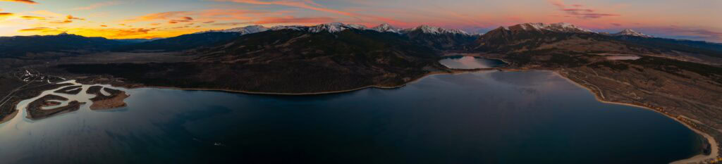wide panorama view of twin lakes with snow capped peaks in colorado