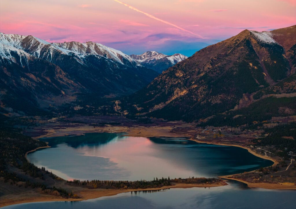 sunrise from above twin lakes in colorado with snow capped peaks
