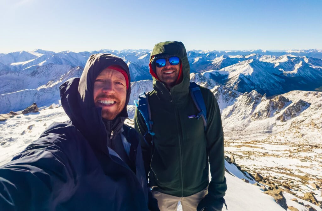 two hikers smile at the camera from a top la plata peak
