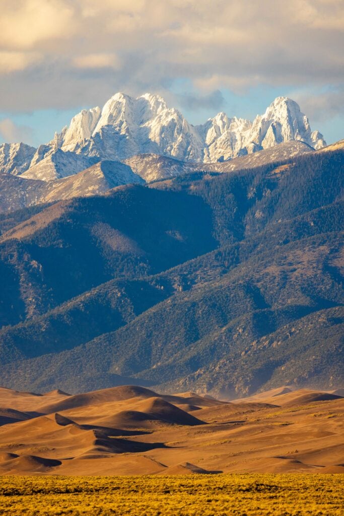 the great sand dunes in colorado with snow capped peaks of the sangre de cristo peaks