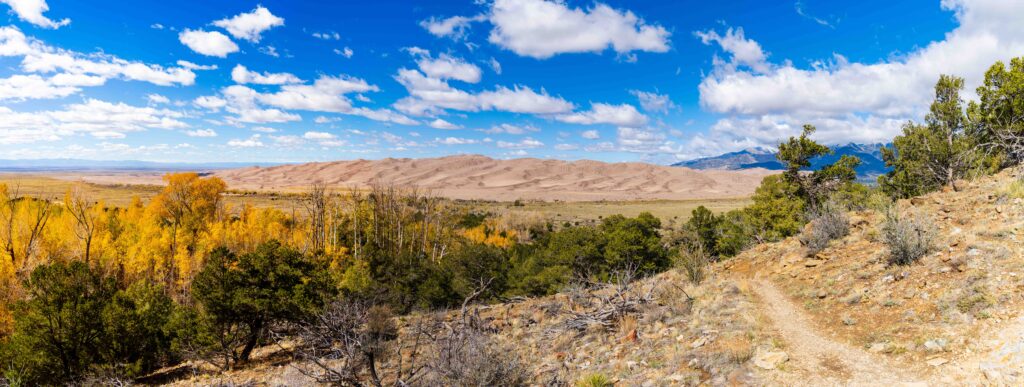 panorama view point on a trail looking out at the great sand dunes in colorado