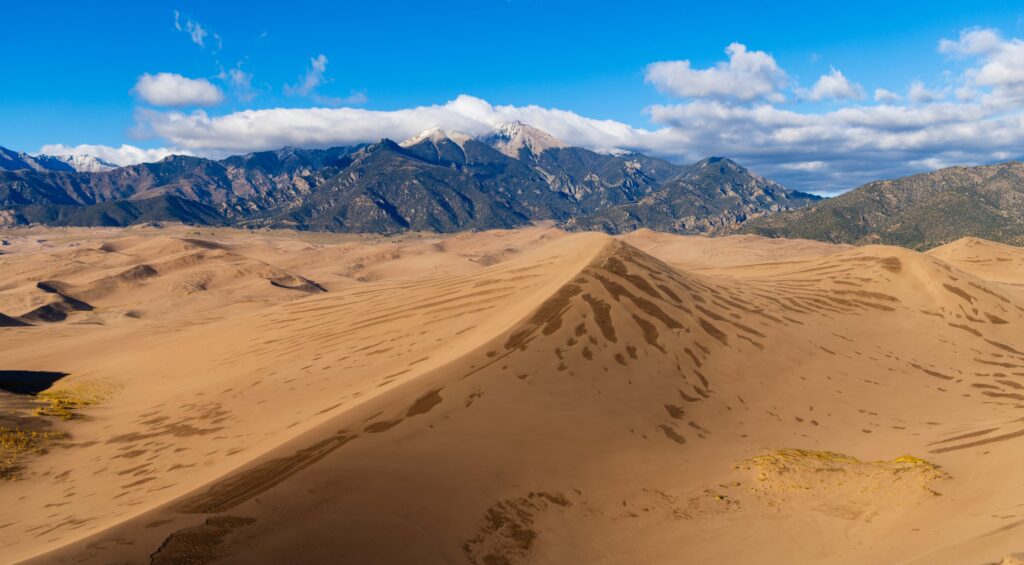 sand dunes and snow capped mountains in colorado